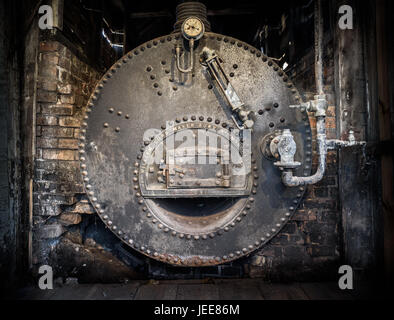 An old cast iron industrial boiler still in it's building at the Lion Salt Works, Cheshire.. Stock Photo