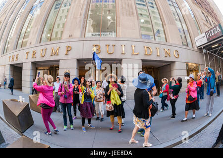 Hordes of Asian tourists amuse themselves in front of the Trump building at 40 Wall Street in New York on Thursday, June 22, 2017.  (© Richard B. Levine) Stock Photo