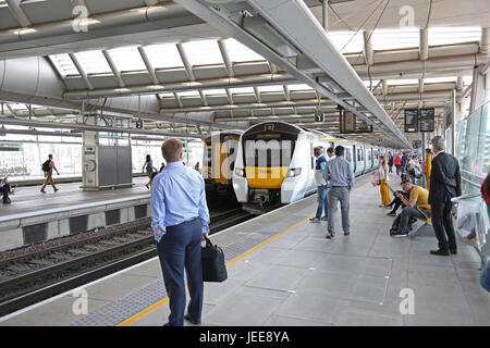 Passengers wait for a new Siemens Series 700 Thameslink train arriving at Blackfriars Station, London. The new station spans the River Thames. Stock Photo