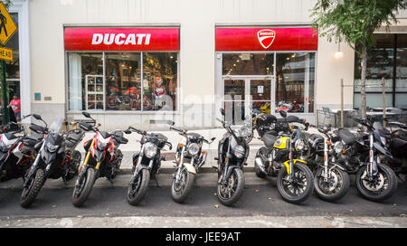Ducati motorcycles and other brands are lined up in front of the Ducati dealership in the Soho neighborhood of New York on Wednesday, June 21, 2017. Harley-Davidson is reported to be preparing a bid for Ducati motorcycles in a bid worth $1.67 billion. Volkswagen is selling their Ducati brand and Bajaj Auto, an Indian motorcycle manufacturer and several buyout firms are also interested in the high performance bike company.  (© Richard B. Levine) Stock Photo