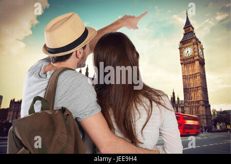 Back view of a traveling young couple and looking up to the Big Ben. Travel concept. Stock Photo