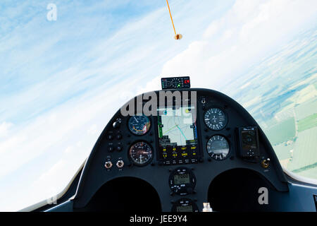 pilots eye view of Modern instrument panel in a Schemmp Hirth Duo Discus high performance two seat glider thermalling over the UK. Stock Photo