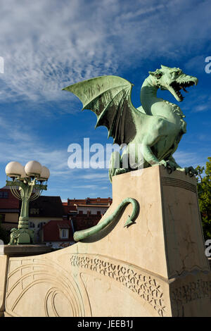 Green copper Dragon statue on concrete pedestal of Dragon Bridge over the Ljubljanica river symbol of Ljubljana Slovenia Stock Photo