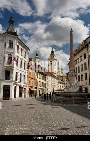 The Town Square of Ljubljana Slovenia with the Robba Fountain of Three Rivers obelisk and the city Cathedral St Nicholas Catholic church Stock Photo