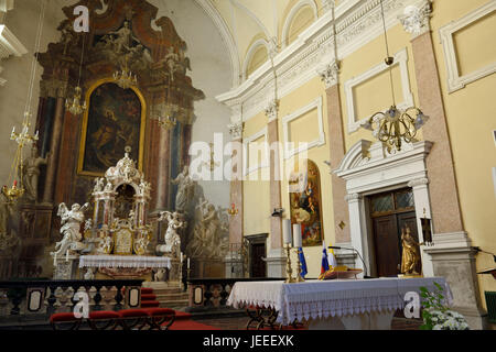Interior sanctuary of Saint James parish Catholic church in Ljubljana Slovenia with altar and ornate tabernacle with carved stone sculptures Stock Photo