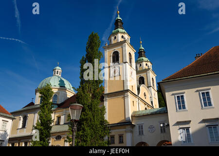 Clock and Bell towers with copper dome of St. Nicholas Catholic church Ljubljana Cathedral from Pogacar Square Ljubljana Slovenia Stock Photo