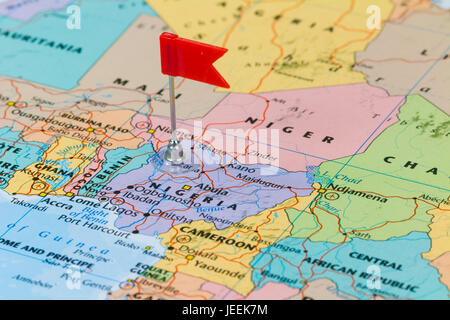 Photo of Nigeria marked by red flag in holder. Country on African continent. Stock Photo