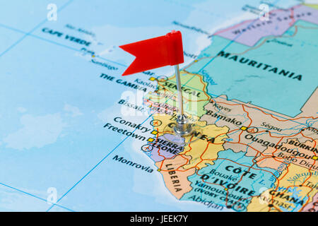 Photo of Sierra Leone marked by red flag in holder. Country on African continent. Stock Photo