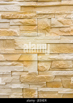 Modern sandstone stone wall background texture. Stock Photo