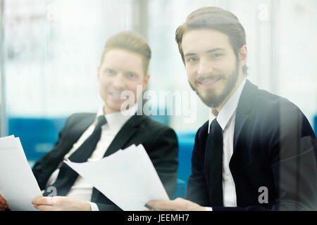 Two traders or bankers with papers looking at camera Stock Photo