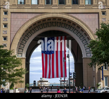 Large USA flag hanging in arch, Boston Harbor hotel, Rowes wharf,  Boston, Massachusetts, USA Stock Photo