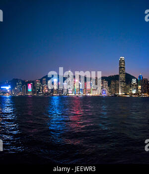 Square cityscape of Hong Kong Island lit up at sunset, China. Stock Photo