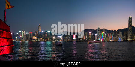 Horizontal panoramic cityscape of Hong Kong Island lit up at sunset, China. Stock Photo