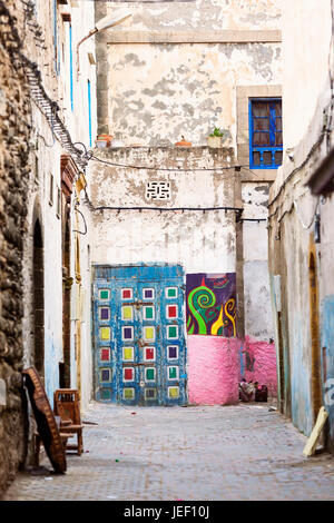 Colourful painted door and grafitti, wallart, street art, in an alleyway of the old medina, Essaouira Stock Photo