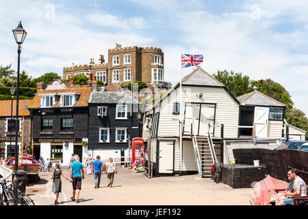 Broadstairs, Bleak House on cliff top, overlooking the old white clapboard wooden lifeboat house. Flagpole with Union Jack flying.People. Stock Photo