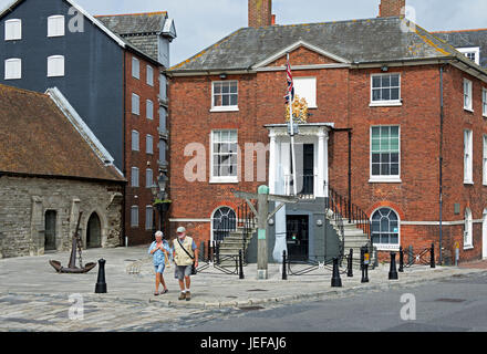 Couple walking past the old Customs House, Poole, Dorset, England UK Stock Photo