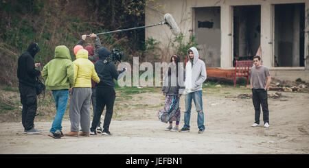 Behind the scene. Film crew team filming movie scene on outdoor location. Group cinema set Stock Photo