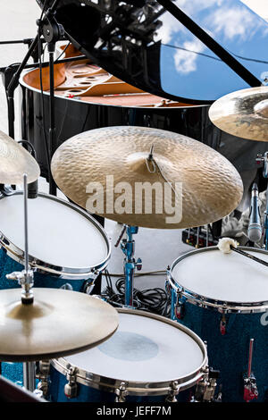 set of drums, microphones and wires on stage before performance of street drummer Stock Photo