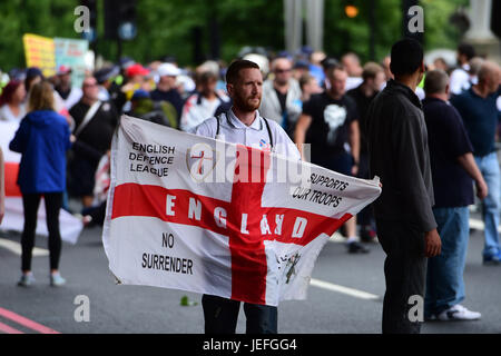 A man holds a flag during an English Defence League (EDL) protest in central London. Stock Photo