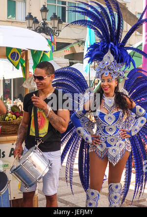 Brazilian samba Dancer in bikini and feathers drummer. International event parade, Torremolinos, Spain. Stock Photo