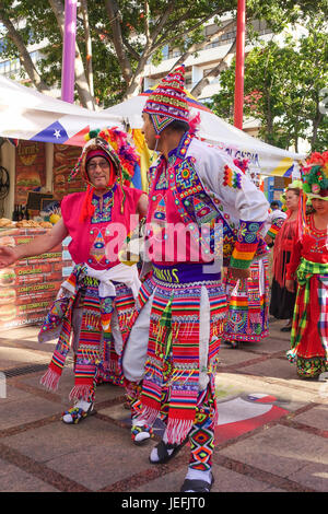 Dance group in Bolivian traditional costumes on food event, parade, International event Spain. Stock Photo