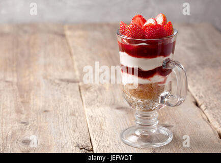 not baking cheesecake with strawberries on old wooden background Stock Photo