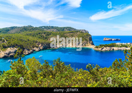 View of stunning sea bay with boats on water on Ibiza northern coast, Spain Stock Photo