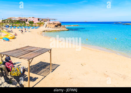 CALA COMTE BEACH, IBIZA ISLAND - MAY 17, 2017: view of sandy Cala Comte beach and restaurant building on shore, Ibiza island, Spain. Stock Photo