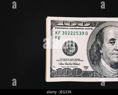 One hundred dollars on table