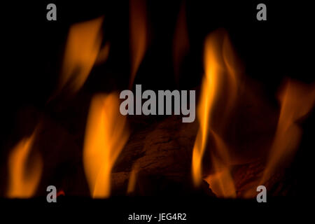 Abstract Image of Flames against a dark backgrouind.  Using your imagination, you can almost see shapes of different creatures in the fire. Stock Photo