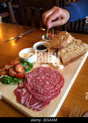 Corbridge, England, UK.  Antipasti in the Black Bull Pub: salami, cherry tomatoes, olives, bread, hummus, buffalo mozzarella. Stock Photo