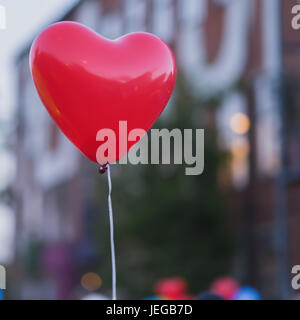 LED red balloon in forme Heart and additional silhouette of heart in sky at night. Romantic style love concept, Valentine's holiday. Square background, place for text Stock Photo