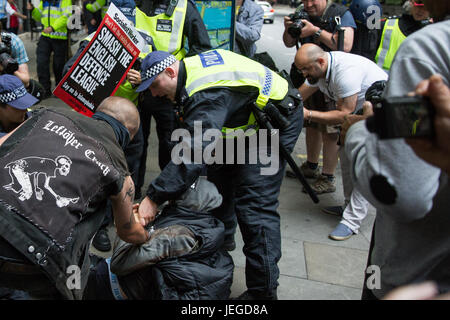 London, UK. 24th June, 2017. Police officers restrain an anti-fascist after a brief clash with members of the English Defence League who had approached the anti-fascist counter-protest on the edge of Trafalgar Square. Credit: Mark Kerrison/Alamy Live News Stock Photo