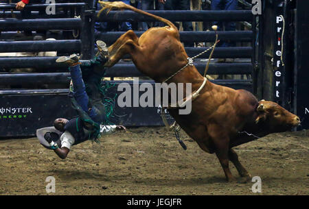 (170625) -- TORONTO, June 25, 2017 (Xinhua)-- Cowboy Juliano Antonio Da Silva of Brazil falls down off a bull during the competition of the 2017 Professional Bull Riders (PBR) Monster Energy Canada Tour at Ricoh Coliseum in Toronto, Canada, June 24, 2017. (Xinhua/Zou Zheng)(wll) Stock Photo