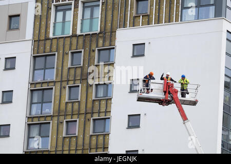 Bootle, Merseyside, UK. 25th June, 2017. Two high-rise blocks on St James Drive in Bootle, Merseyside failed fire safety tests carried out this week. On Sunday June 25, 2017, contractors are removing cladding after the landlord instructed the cladding to be removed immediately. There has been no evacuation of the affected tower blocks. Credit: Christopher Middleton/Alamy Live News Stock Photo