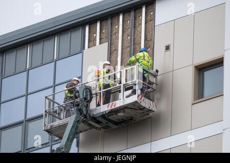 Bootle, Merseyside, UK. 25th June, 2017. Two high-rise blocks on St James Drive in Bootle, Merseyside failed fire safety tests carried out this week. On Sunday June 25, 2017, contractors are removing cladding after the landlord instructed the cladding to be removed immediately. There has been no evacuation of the affected tower blocks. Credit: Christopher Middleton/Alamy Live News Stock Photo
