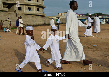 June 25, 2017 - Juba, Jubek, South Sudan - A father and sons arrive to the Malkei neighborhood of Juba, South Sudan for the start of Eid al-Fatr, the celebration marking the end of the Muslim Holy month of Ramadan. Roughly half the population of South Sudan is Muslim, a legacy of its long domination by the Arab-controlled northern Sudan, which ended in 2011, when South Sudan became the world's newest nation. The country has been in a state of civil war for the past three years, leaving millions of civilians displaced and near famine. (Credit Image: © Miguel Juarez Lugo via ZUMA Wire) Stock Photo