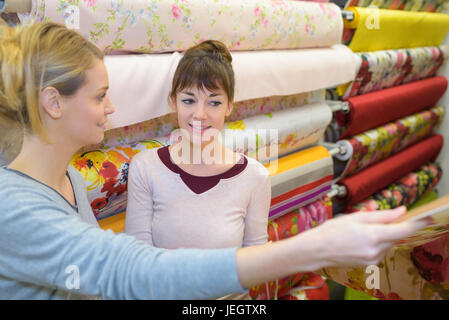 woman chooses colored fabric Stock Photo