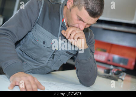 Checking Before Building Checking the building plans before starting Stock Photo - Alamy
