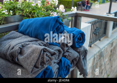 A stack of folded blankets in outdoors restaurant Stock Photo