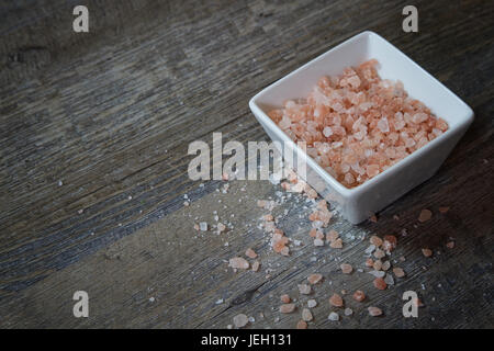 Bowl of  Pink Himalayan Salt on Rustic Wood Background with text space or copy space Stock Photo