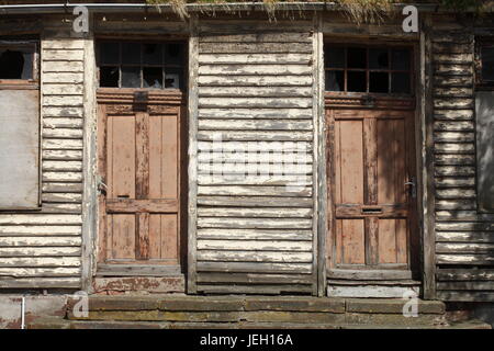 old doors on an old condemned wooden house Stock Photo