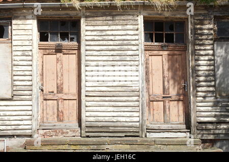 old doors on an old condemned wooden house Stock Photo