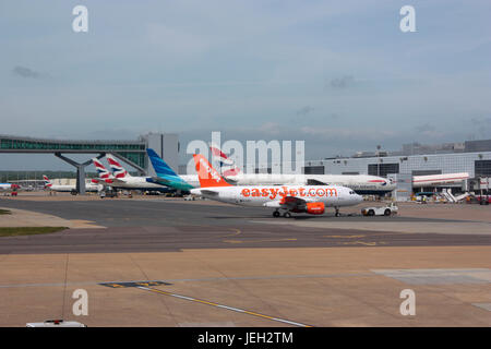 Civil aviation. London Gatwick Airport, UK, with an easyJet Airbus A319 and other planes at their gates. Commercial air travel and flights. Stock Photo