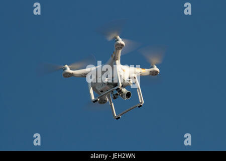 DJI Phantom 3 quadcopter photographic drone hovering, with camera pointing downwards Stock Photo