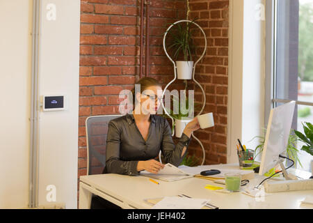 Three business women in the office at meeting Stock Photo
