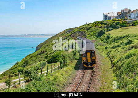 the st.ives branch railway line passing carbis bay in cornwall, england, britain, uk. Stock Photo