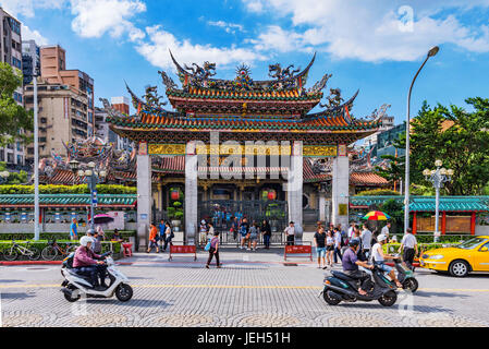 TAIPEI, TAIWAN - JUNE 07: This is the main entrance to Longshan Temple and busy road outside the Temple. The temple is an historic landmark and popula Stock Photo