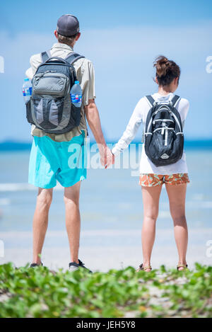 Young couple holding hands go to the beach Stock Photo