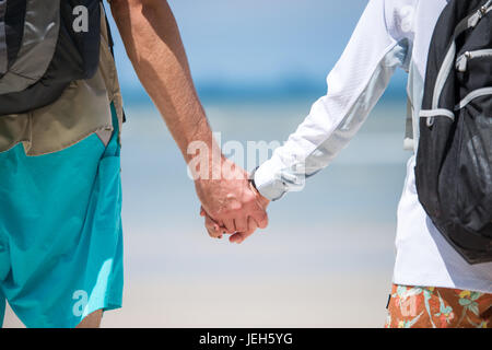Young couple holding hands go to the beach Stock Photo